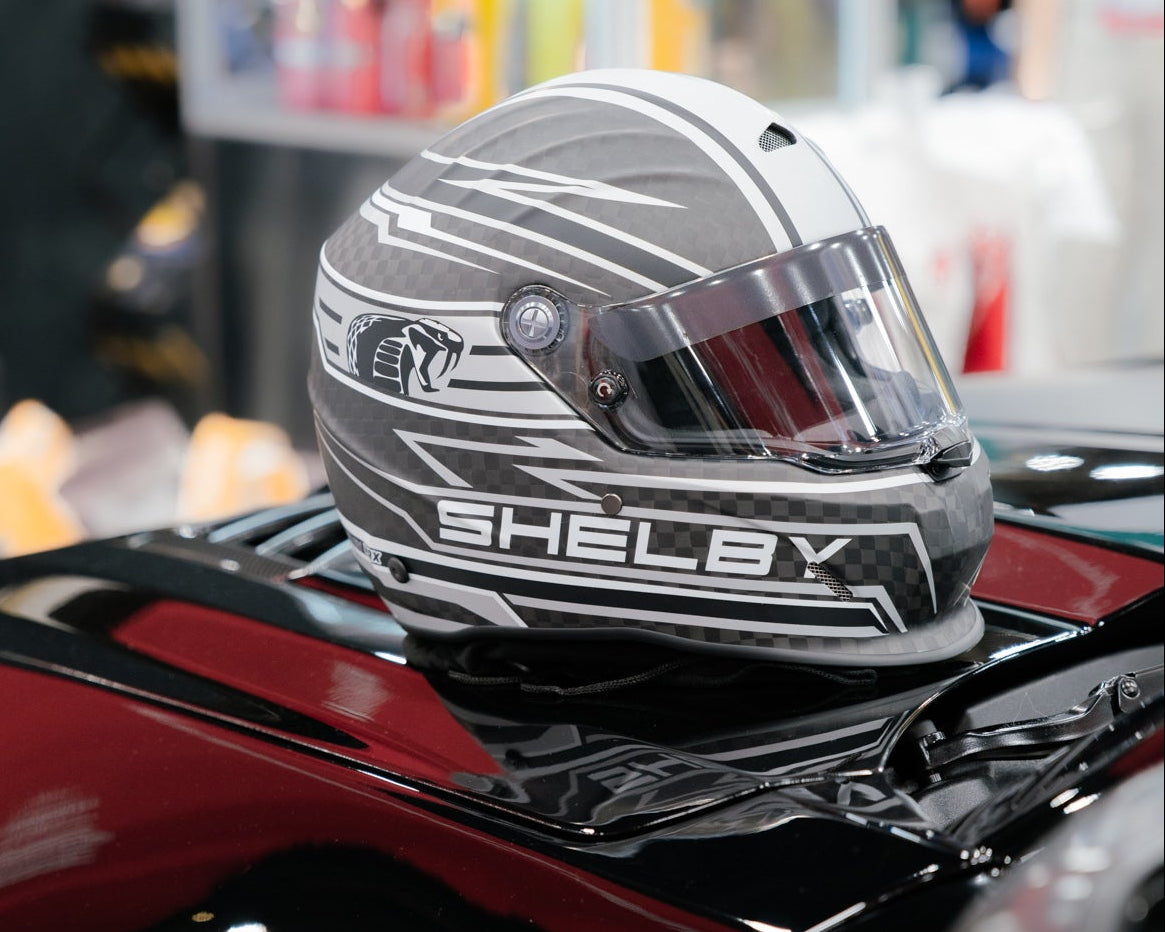 Shelby helmet on a black car with blurred background